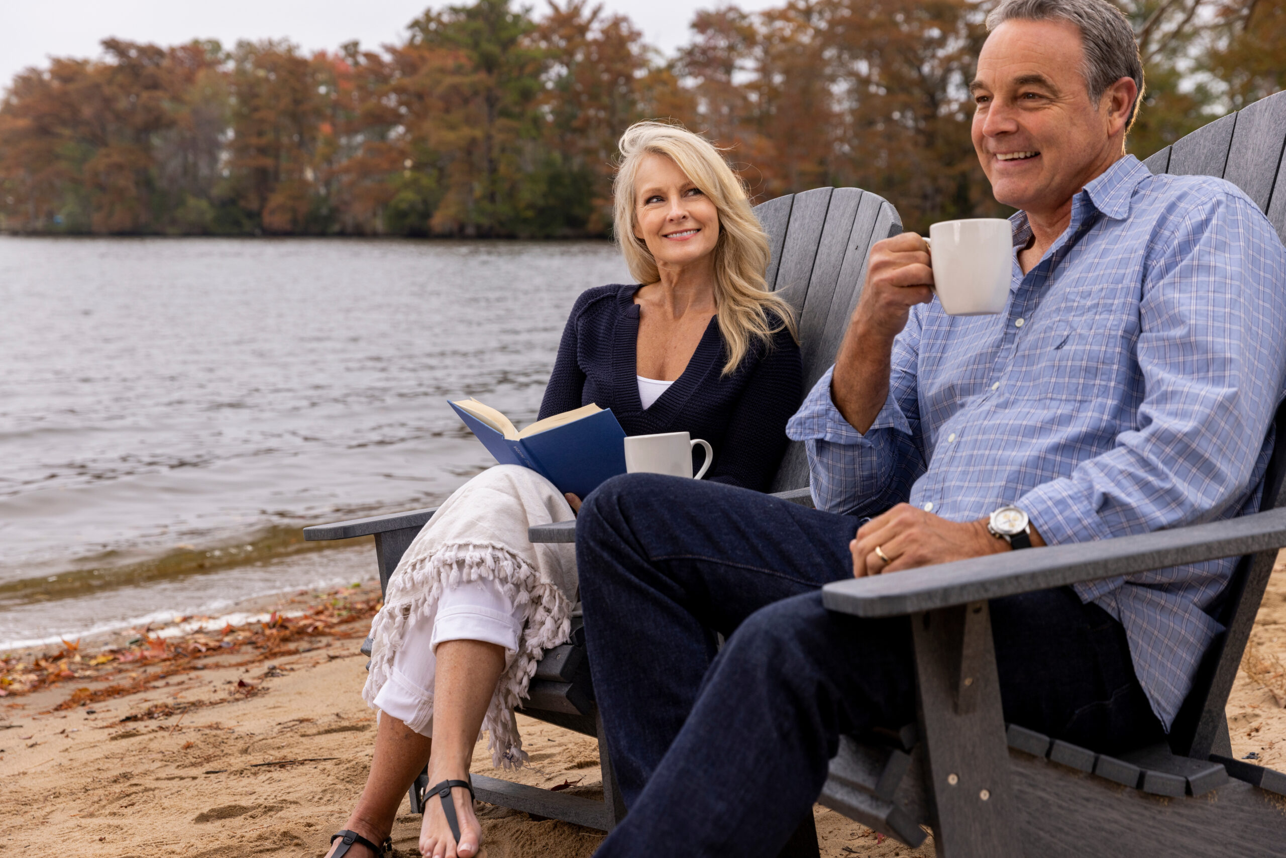Woman relaxing with a book and coffee on the shoreline