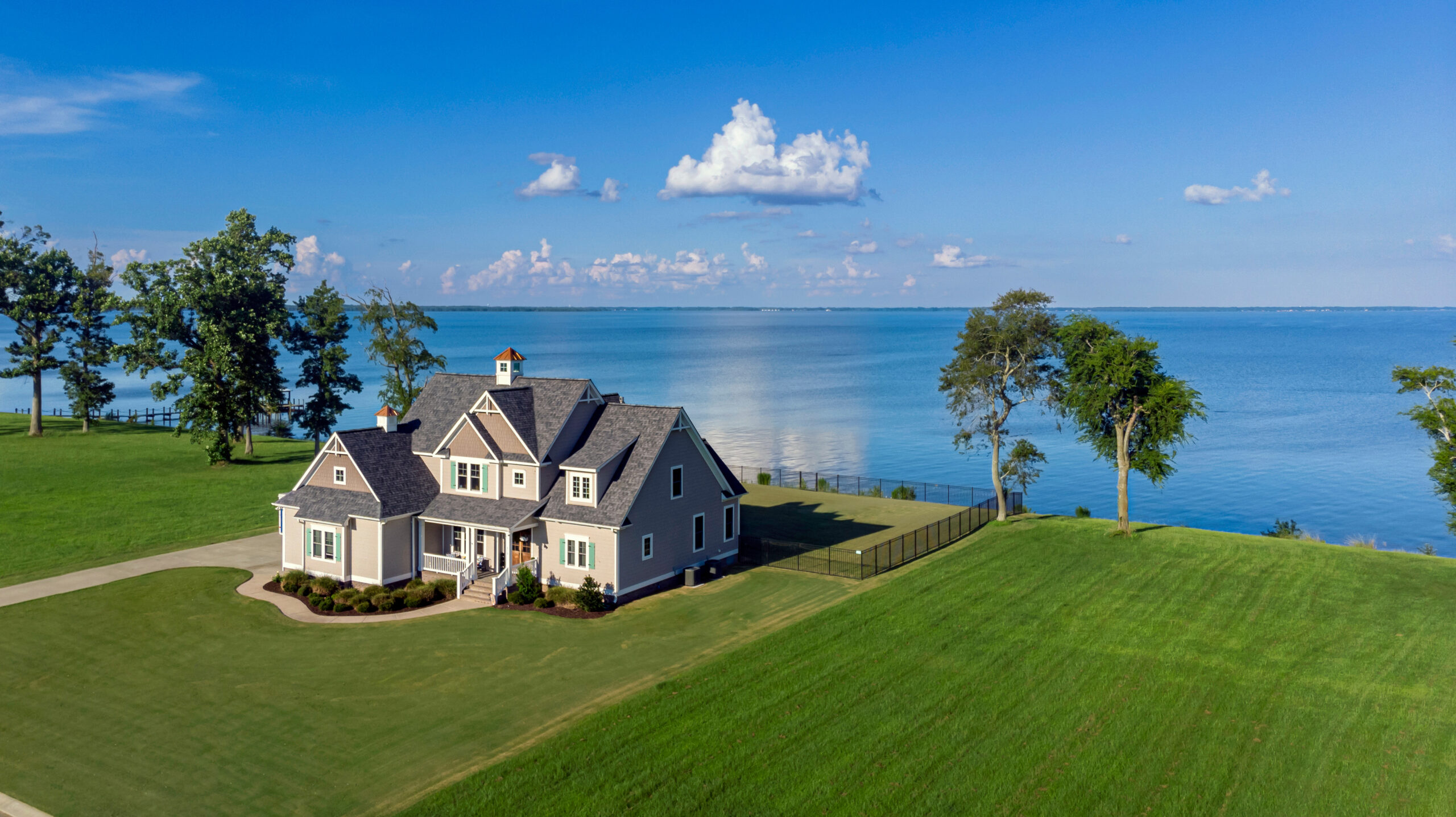 Exterior overview shot of a beautiful house on the shoreline